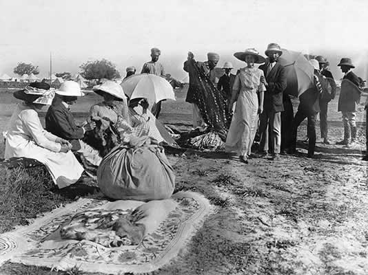 Tradesmen showing their wares in the 10th Hussars encampment. Sylvia Brooke and her brother Basil (centre couple), a captain in the Hussars.